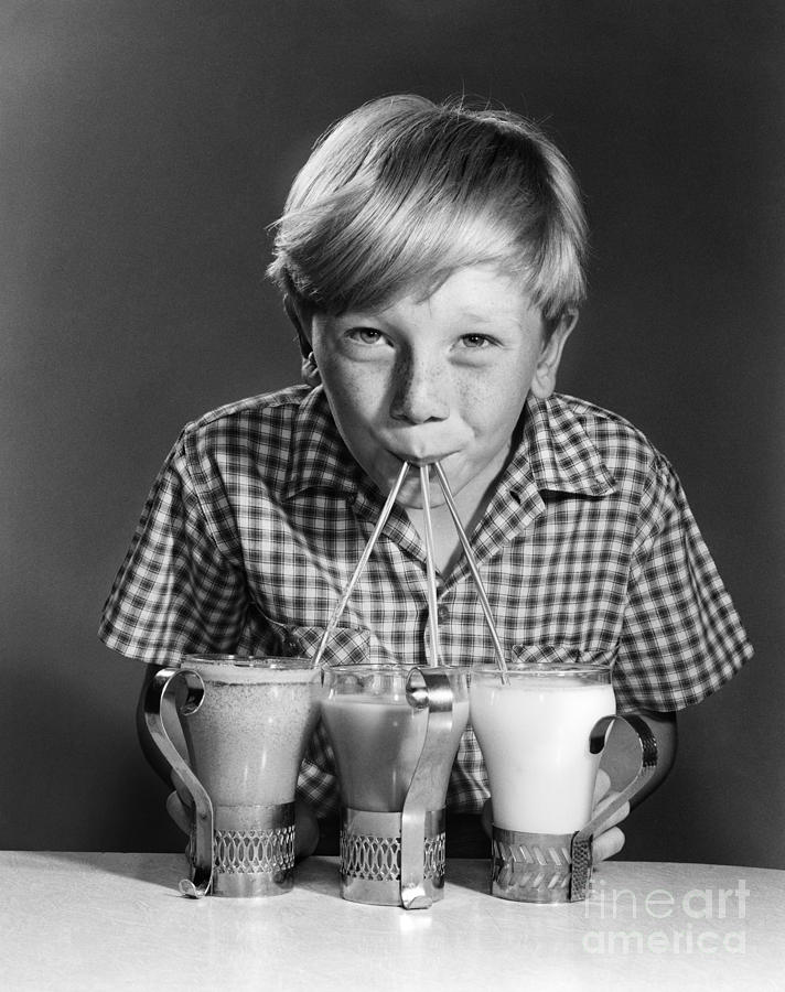 Boy Drinking Three Shakes At Once Photograph by Debrocke/ClassicStock