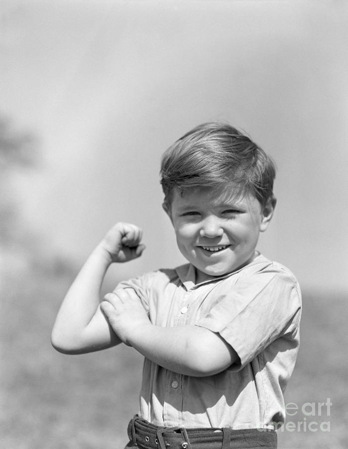 Boy Flexing Muscles, C.1930s Photograph by H. Armstrong Roberts/ClassicStock Boy Flexing Muscles, C.1930s Photograph by H. Armstrong Roberts/ClassicStock