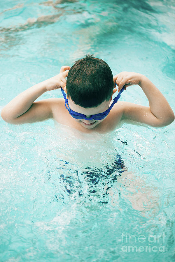Boy in a swimming pool with diving goggles Photograph by Michal Bednarek