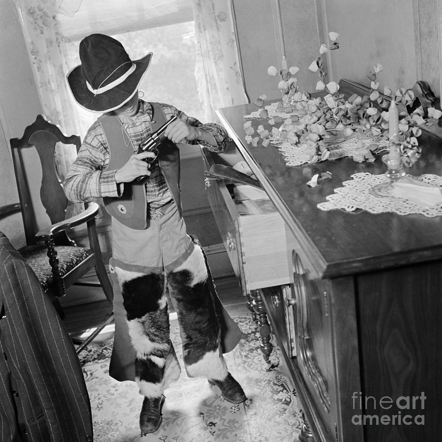Boy In Cowboy Outfit Looking At Real Photograph by H. Armstrong Roberts/ClassicStock