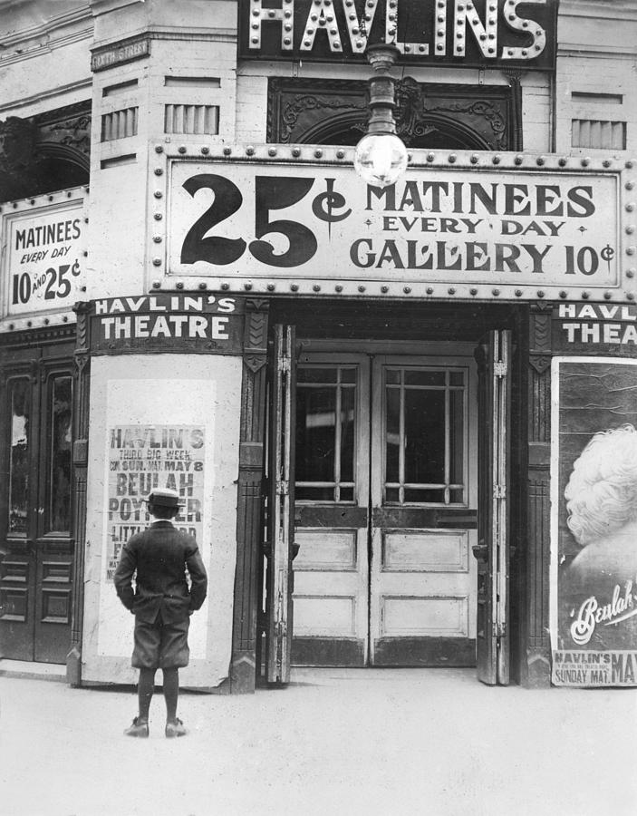 Lewis Wickes Hine Photograph - Boy In Front Of A Movie Theater Showing by Everett