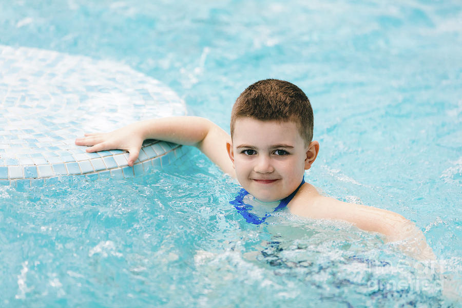 Boy in swimming goggles relaxing jacuzzi. Photograph by Michal Bednarek