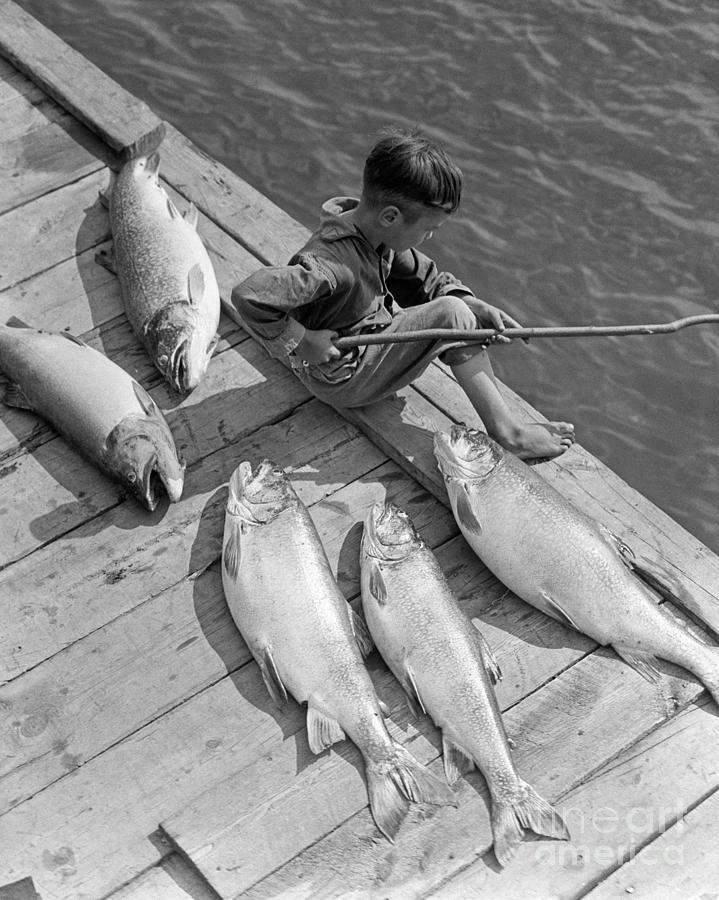 Boy On Dock With Caught Fish Photograph by H. Armstrong Roberts/ClassicStock