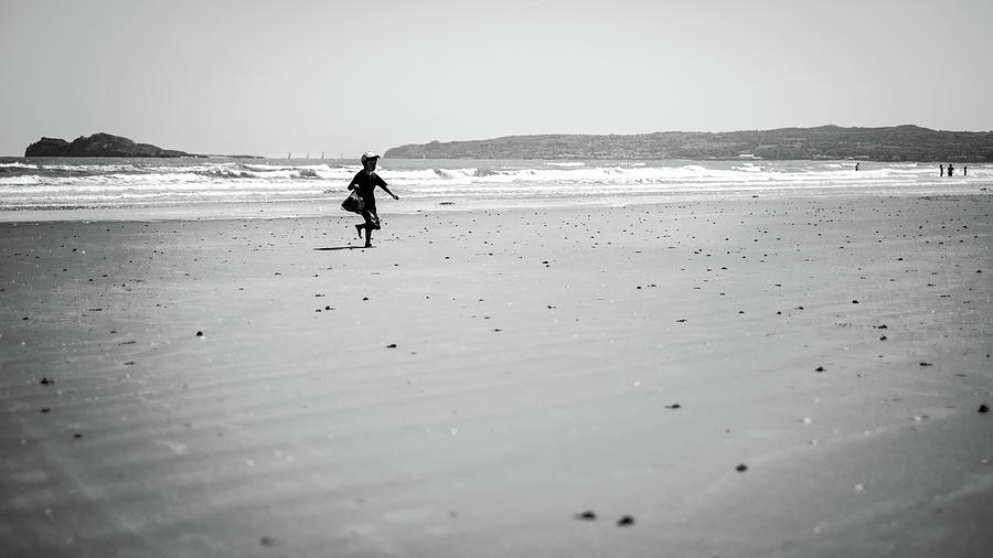 Boy on the beach - Portmarnock, Ireland - Black and white street photography Photograph by Giuseppe Milo