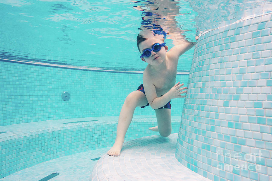 Boy playing in a swimming pool with goggles on Photograph by Michal Bednarek