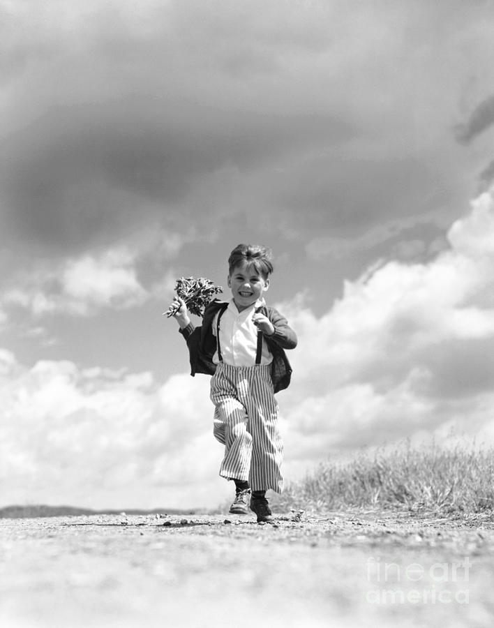 Boy Running With A Bunch Of Flowers Photograph by H. Armstrong Roberts/ClassicStock