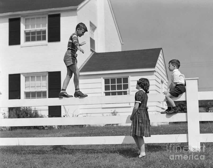 Boy Walking On Fence, C.1950s Photograph by H. Armstrong Roberts/ClassicStock