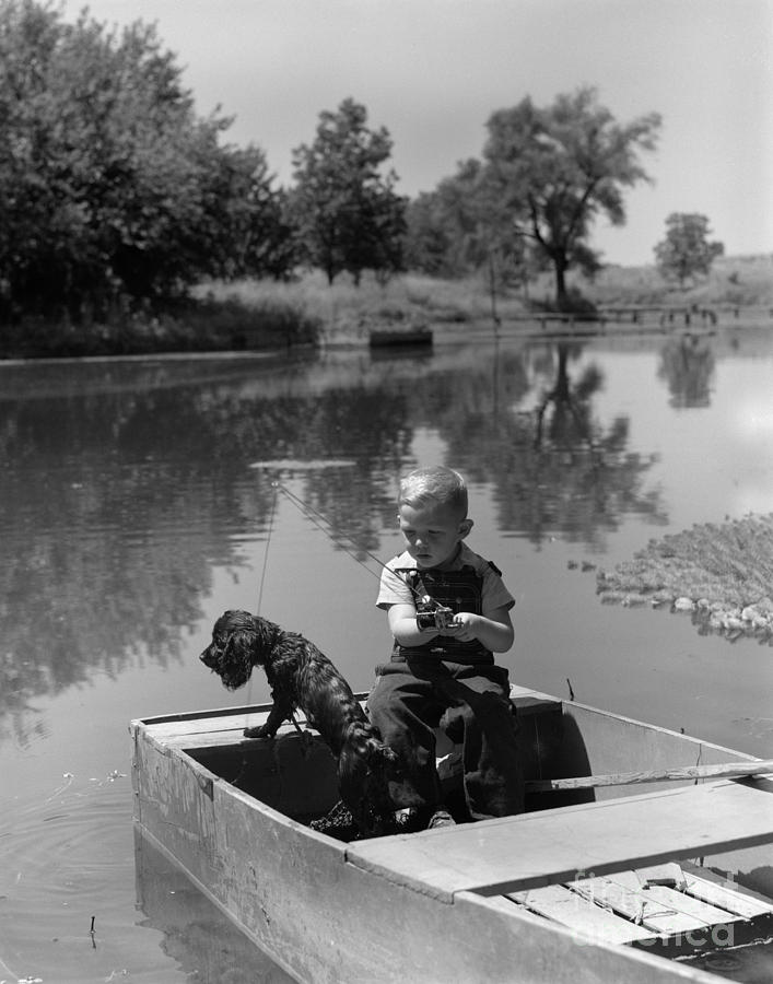 Animal Photograph - Boy With Dog In Fishing Boat by CS Bauer and ClassicStock