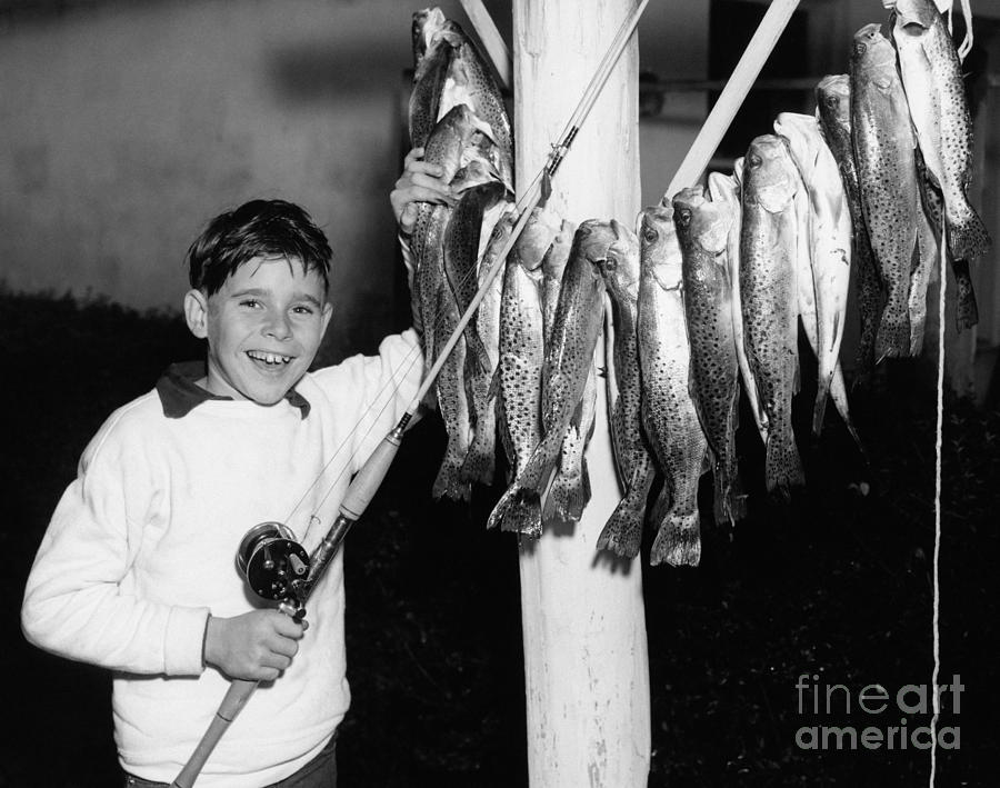 Boy With Fish Catch Photograph by Debrocke/ClassicStock