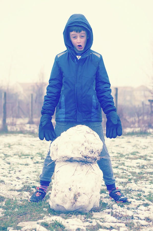 Boy with snowman Photograph by Tom Gowanlock