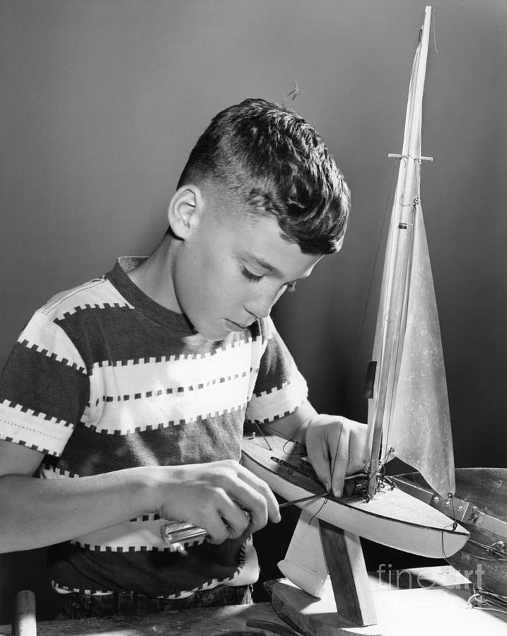 Boy Working On Model Sailboat, C.1950s Photograph by H. Armstrong Roberts/ClassicStock