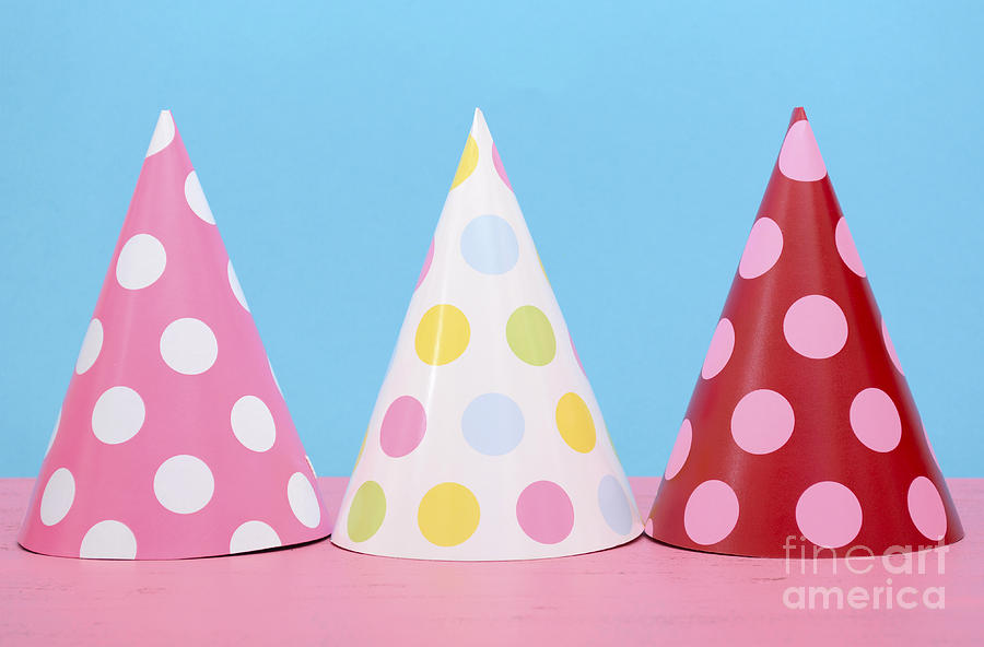 Bright party polka dot party hats.  Photograph by Milleflore Images