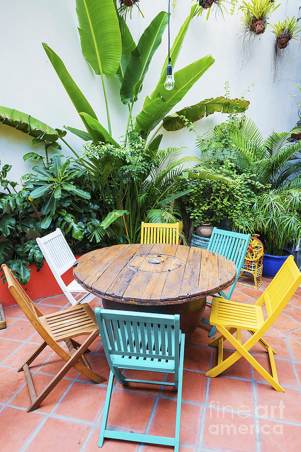Brightly Coloured Wooden Chairs And Table In Garden Photograph by JM Travel Photography