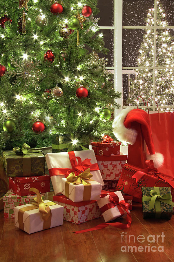 Brightly lit christmas tree with lots of gifts Photograph by Sandra Cunningham