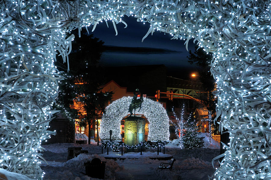 Winter Photograph - Brightly lit Elk antler arches in Jackson Wyoming town square in by Reimar Gaertner
