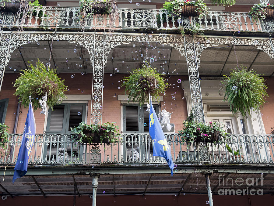 Bubbles blow from an ornate balcony in New Orleans at Mardi Gras Photograph by Louise Heusinkveld