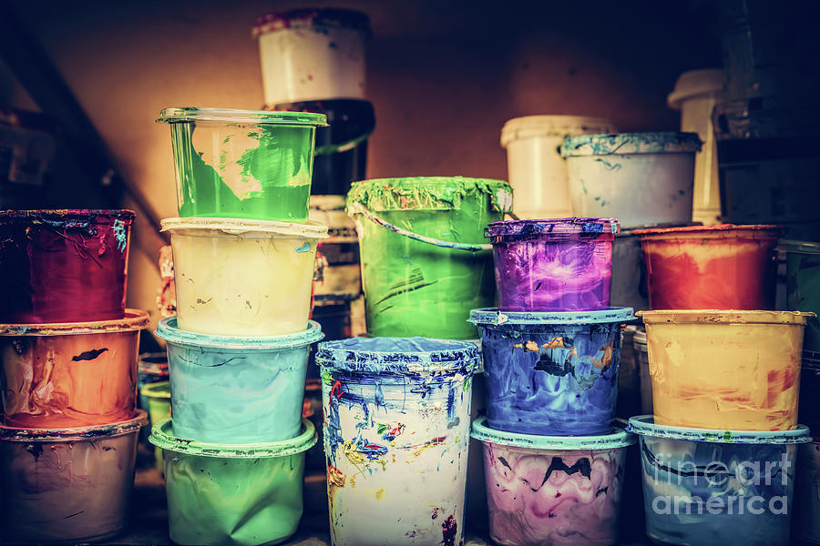 Buckets of liquid paint standing in a workshop. Photograph by Michal Bednarek