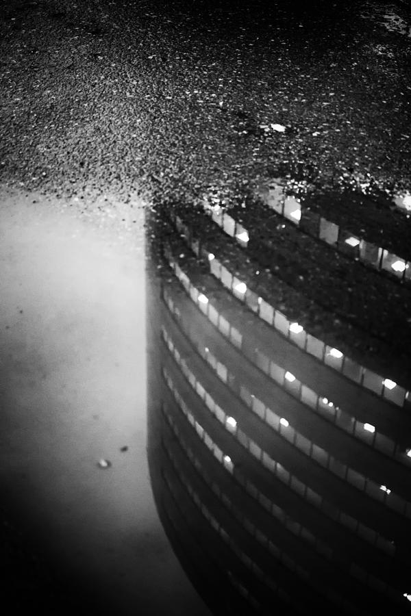 Building Reflection in a Puddle of Water Photograph by John Williams