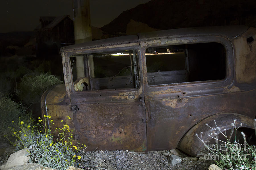 Bullet Ridden Old Car in Junk Yard Photograph by Karen Foley