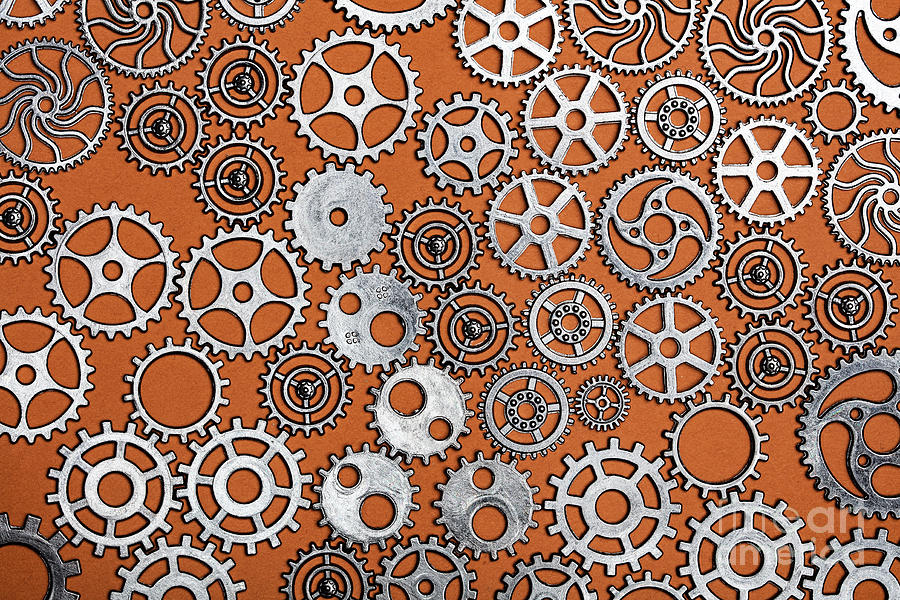 Clock Photograph - Bunch of cogwheels on an orange background. by Michal Bednarek