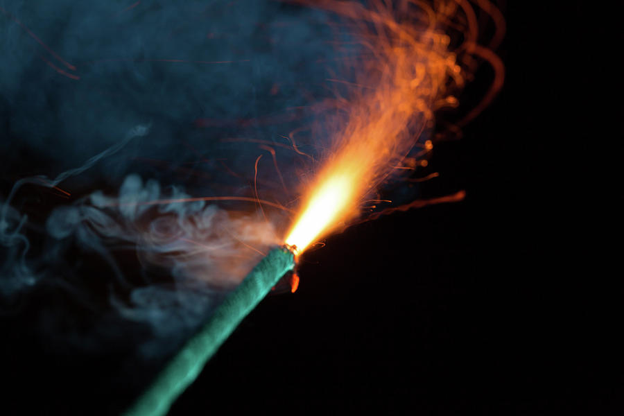 Burning fuse with orange sparks and blue smoke Photograph by Lukasz ...