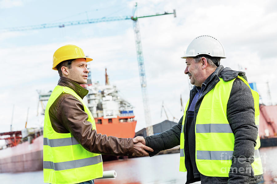 Business handshake in a shipyard. Shipbuilding industry Photograph by Michal Bednarek