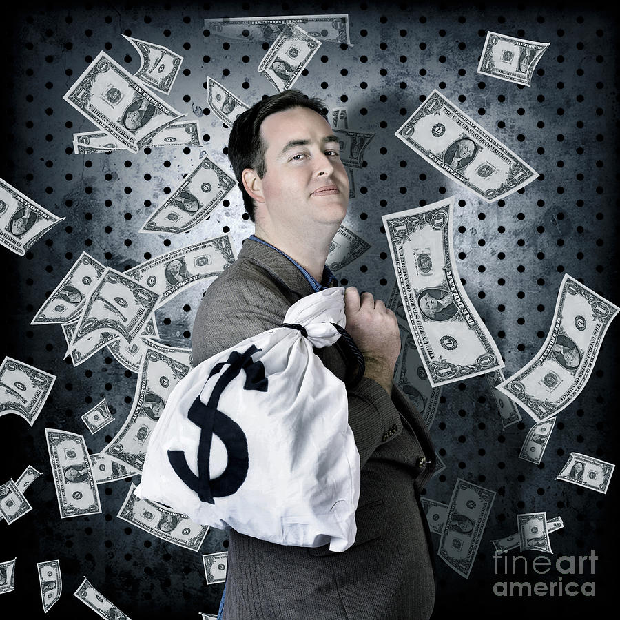 Business man in bank vault with finance money bag Photograph by Jorgo Photography