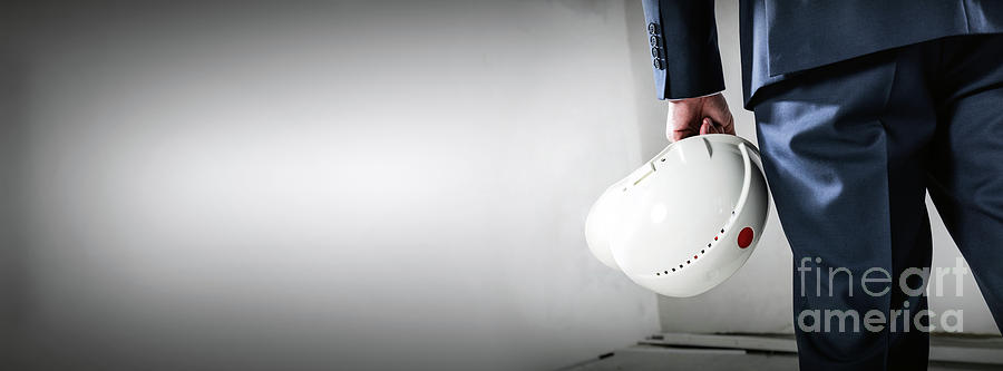 Businessman holding white safety helmet. Banner format Photograph by Michal Bednarek