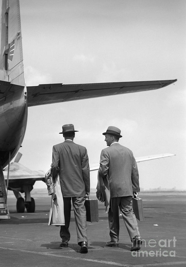 Businessmen Boarding A Plane Photograph by Debrocke/ClassicStock