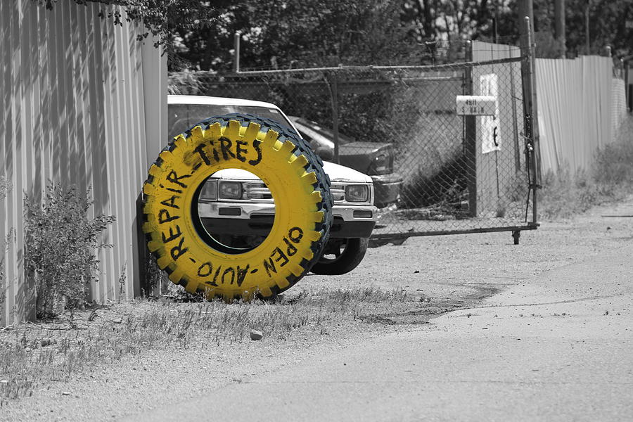 Canary Yellow Tire Sign Selective Color Photograph by Colleen Cornelius