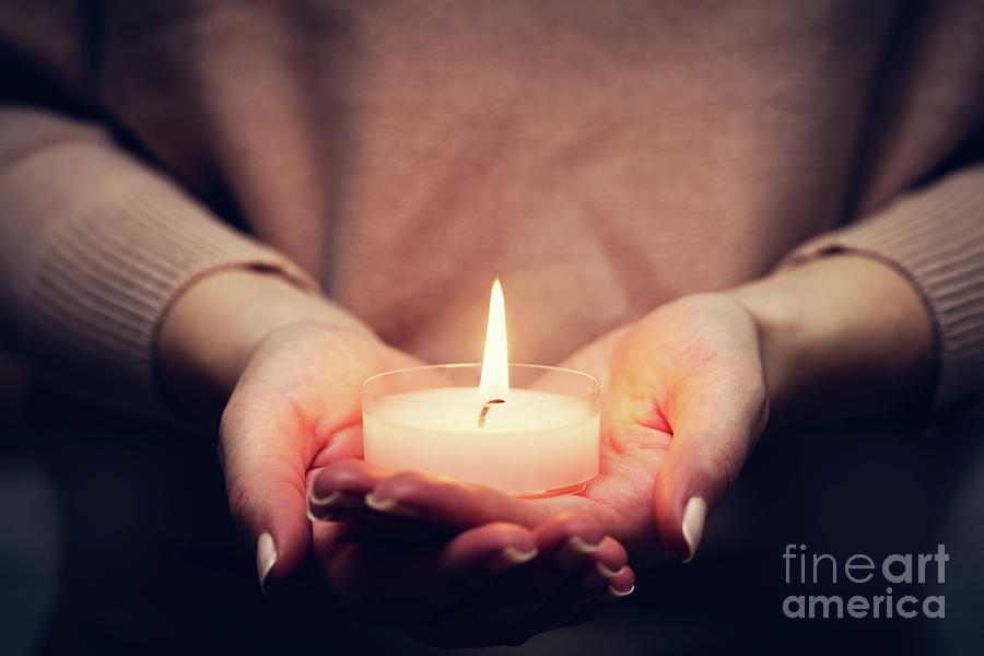 Candle light glowing in womans hands. Praying, faith, religion Photograph by Michal Bednarek