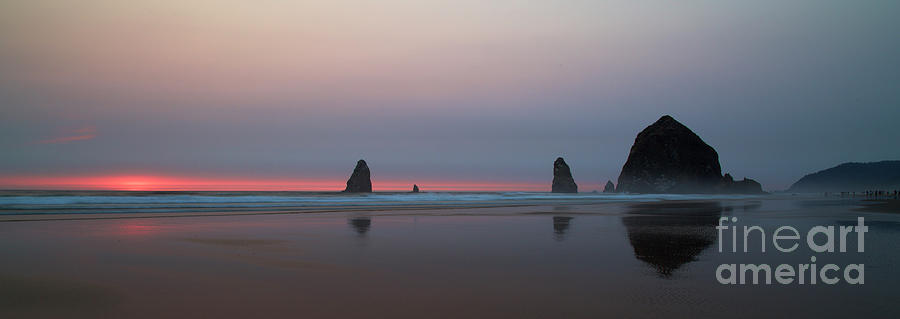 Cannon Beach and Haystack Rock Sunset with a smokey sky Photograph by Bruce Block
