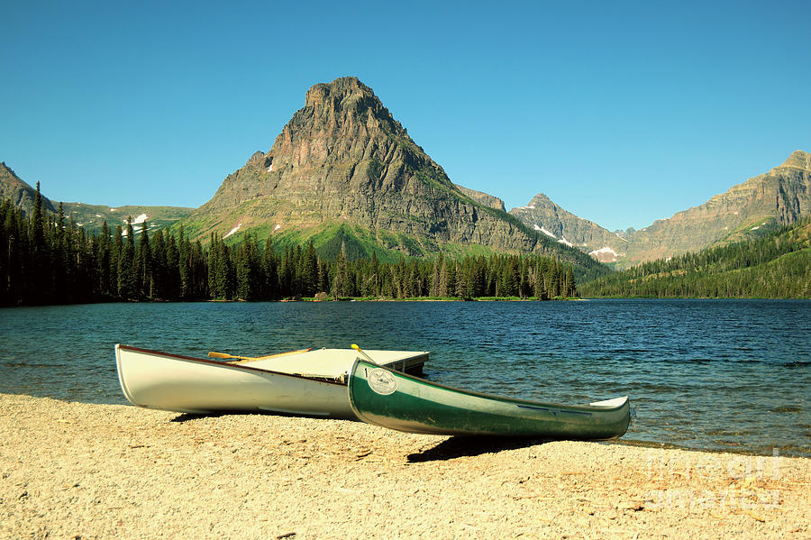 Glacier National Park Photograph - Canoes foreground Mount Sinopah by Jeff Swan
