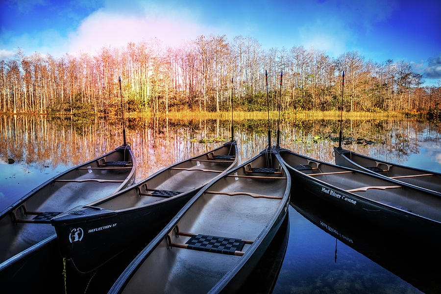 Canoes on the River Photograph by Debra and Dave Vanderlaan