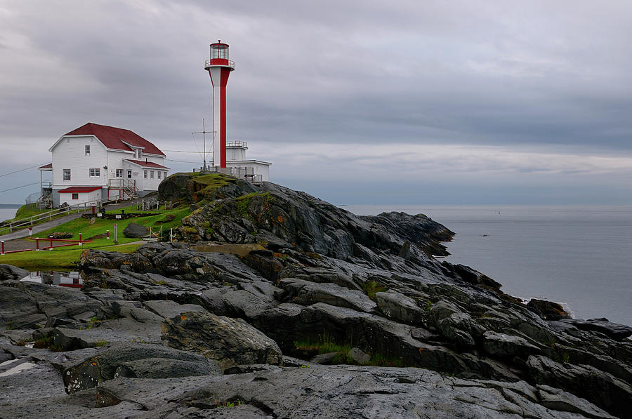 Cape Forchu lighthouse and wet rocks near Yarmouth Nova Scotia Photograph by Reimar Gaertner