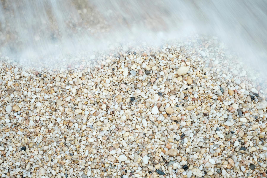 Cape May Diamonds and small smooth pebbles at the tide line on a