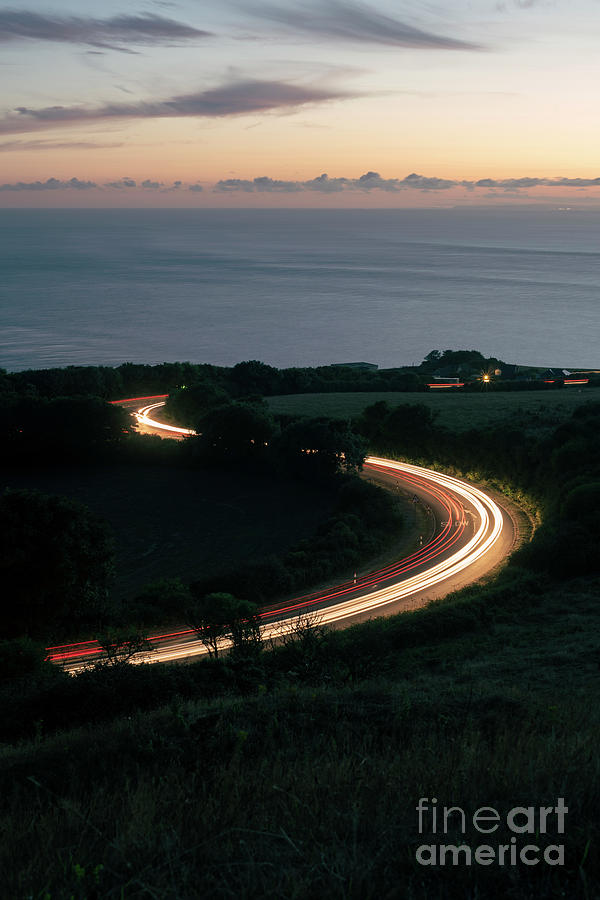 Car lights by the coast Photograph by Clayton Bastiani