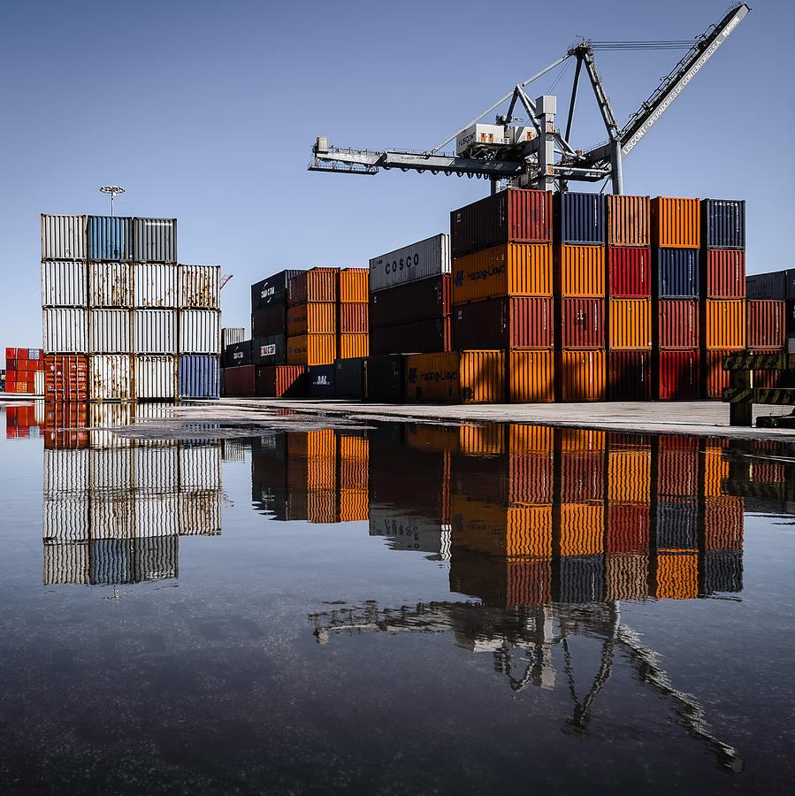 Cargo Containers Reflecting On Large Puddle Photograph