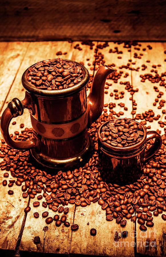 Ceramic coffee pot and mug overflowing with beans Photograph by Jorgo Photography