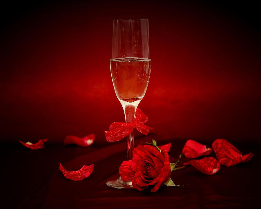 Champagne Glass With Red Roses And Petals Photograph by Serena King