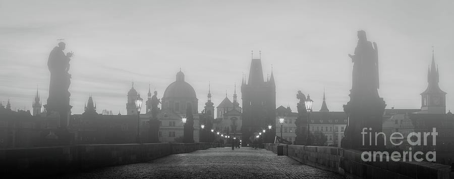 Charles Bridge in fog at sunrise, Prague, Czech Republic. Dramatic statues and medieval towers. Photograph by Michal Bednarek