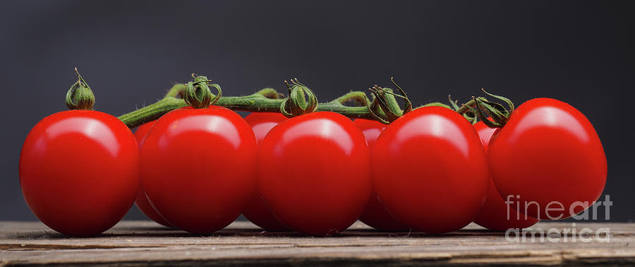 Cherry tomatoes on a wooden table Photograph by Andreas Berheide