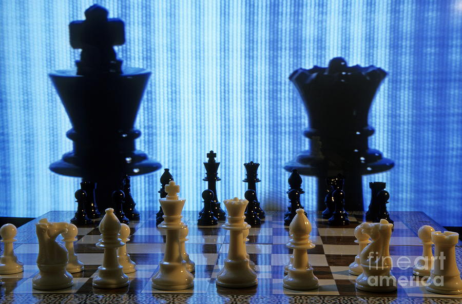 Chess board with King and Queen chess pieces in front of TV scre Photograph by Sami Sarkis