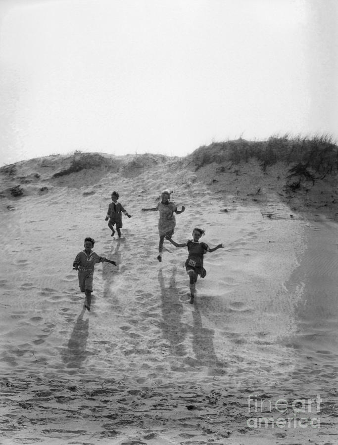 Children Running Down Sand Dune, C.1920s Photograph by H Armstrong Roberts and ClassicStock