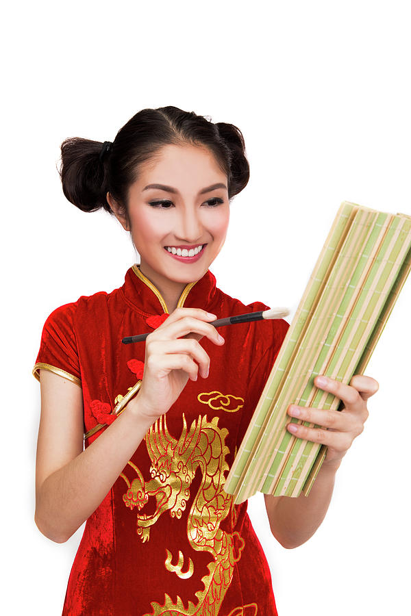 Chinese lady in cheongsam write a bamboo book by ink  Photograph by Anek Suwannaphoom