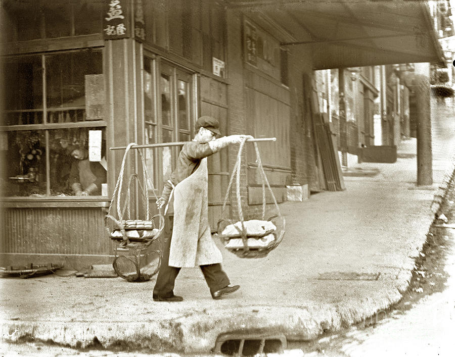 San Francisco Photograph - Chinese man carrying produce in baskets balanced on pole over shoulder in San Francisco 1900 by Monterey County Historical Society