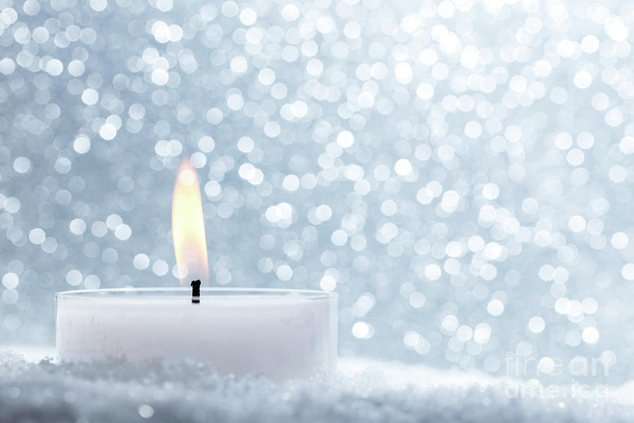 Chistmas candle glowing on glitter background. Photograph by Michal Bednarek