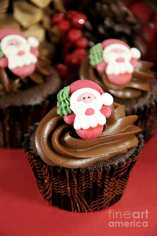 Christmas chocolate cupcakes with Santa faces Photograph by Milleflore Images
