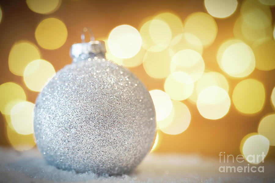 Christmas glass ball in snow. Glitter lights background Photograph by Michal Bednarek