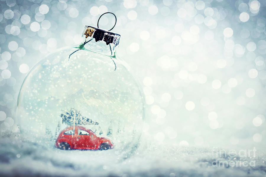 Christmas glass ball in snow with miniature winter world inside Photograph by Michal Bednarek